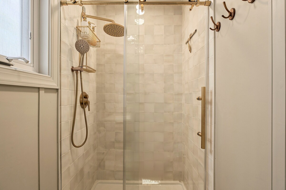 Walk-in shower with brass rainfall head