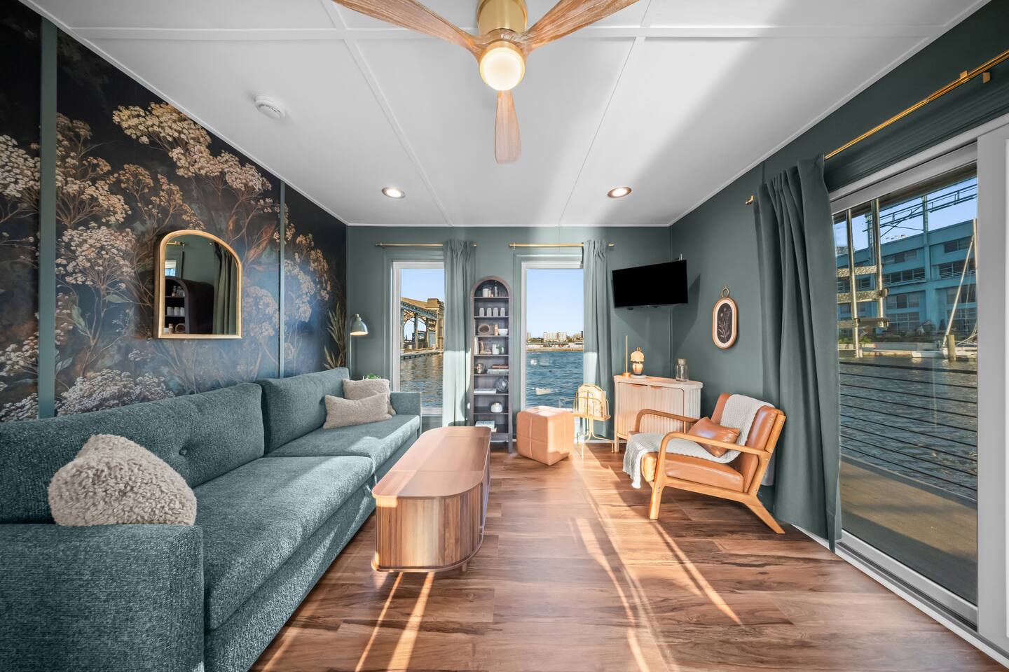 Living room with botanical mural and river views