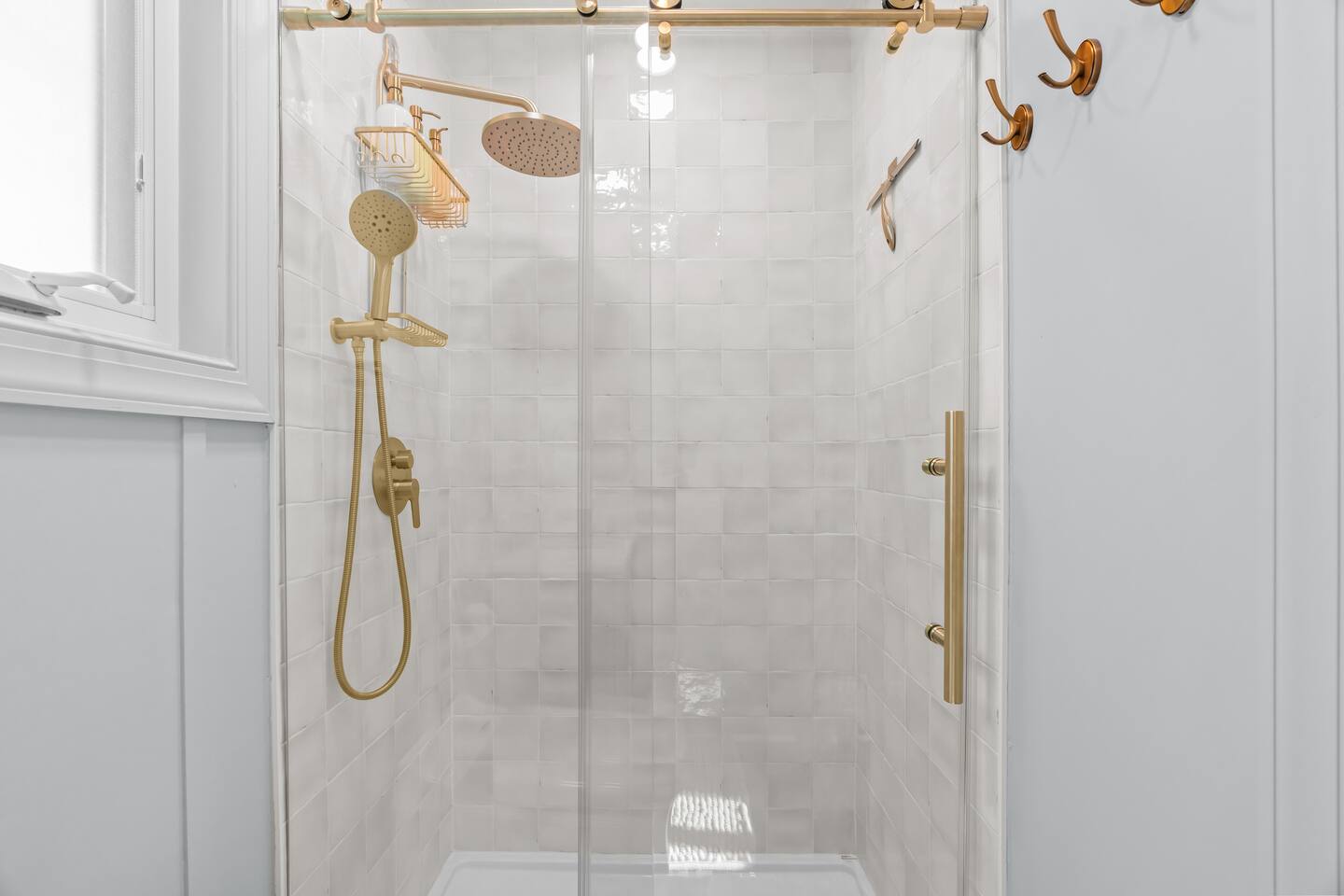 Bathroom with glass shower and brass fixtures
