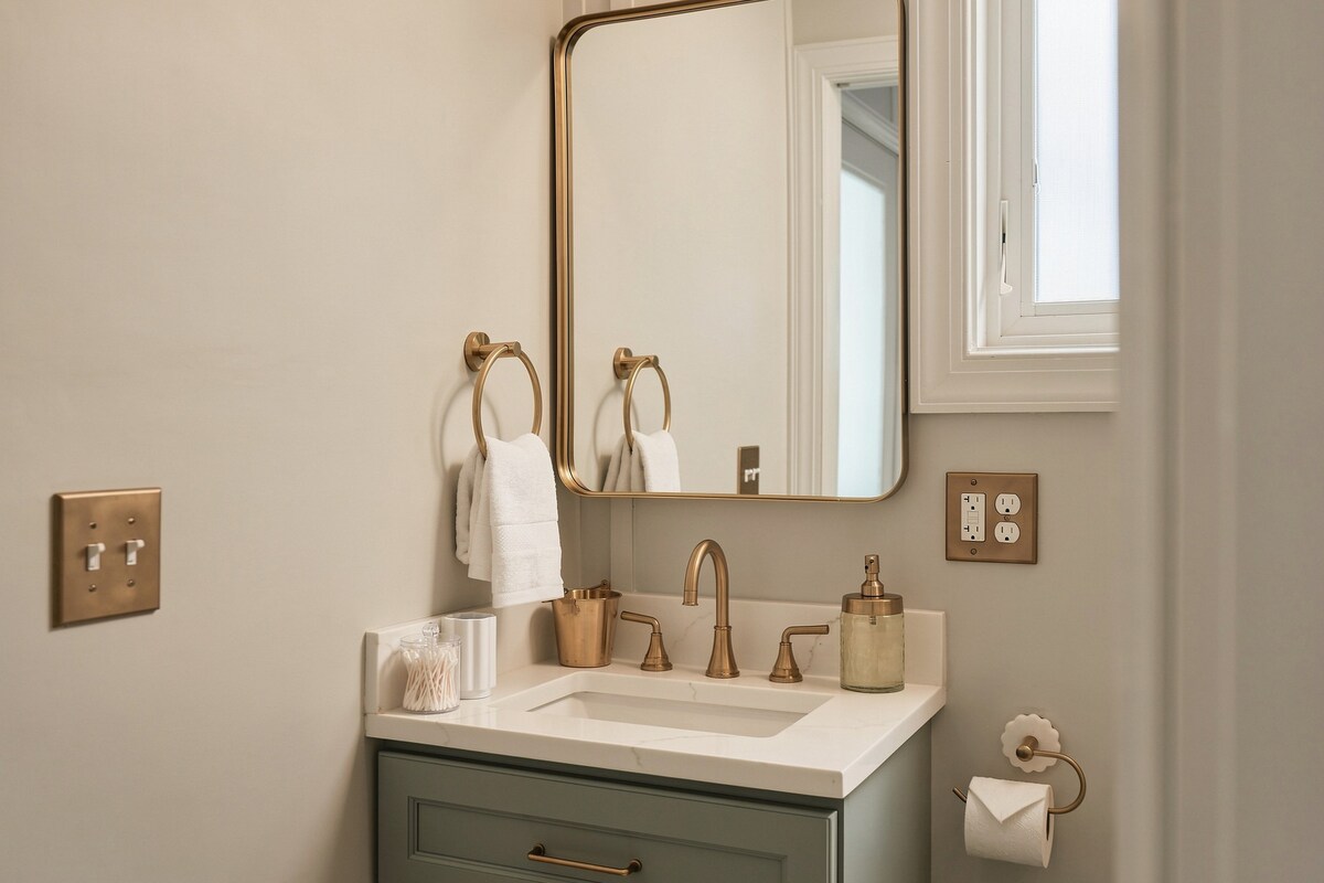 Vanity with brass faucet and mirror