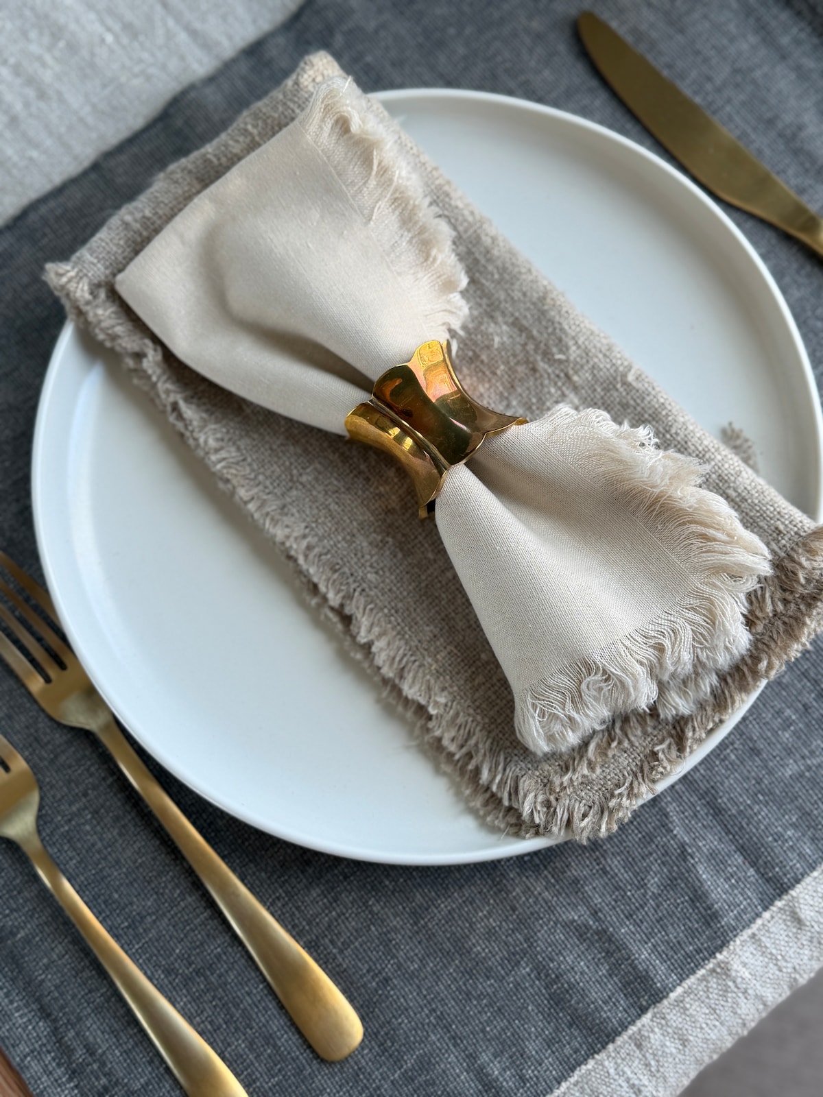 Table setting with linen and brass