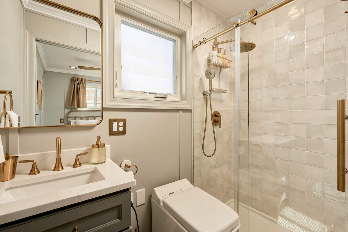 Bathroom with glass shower and brass fixtures